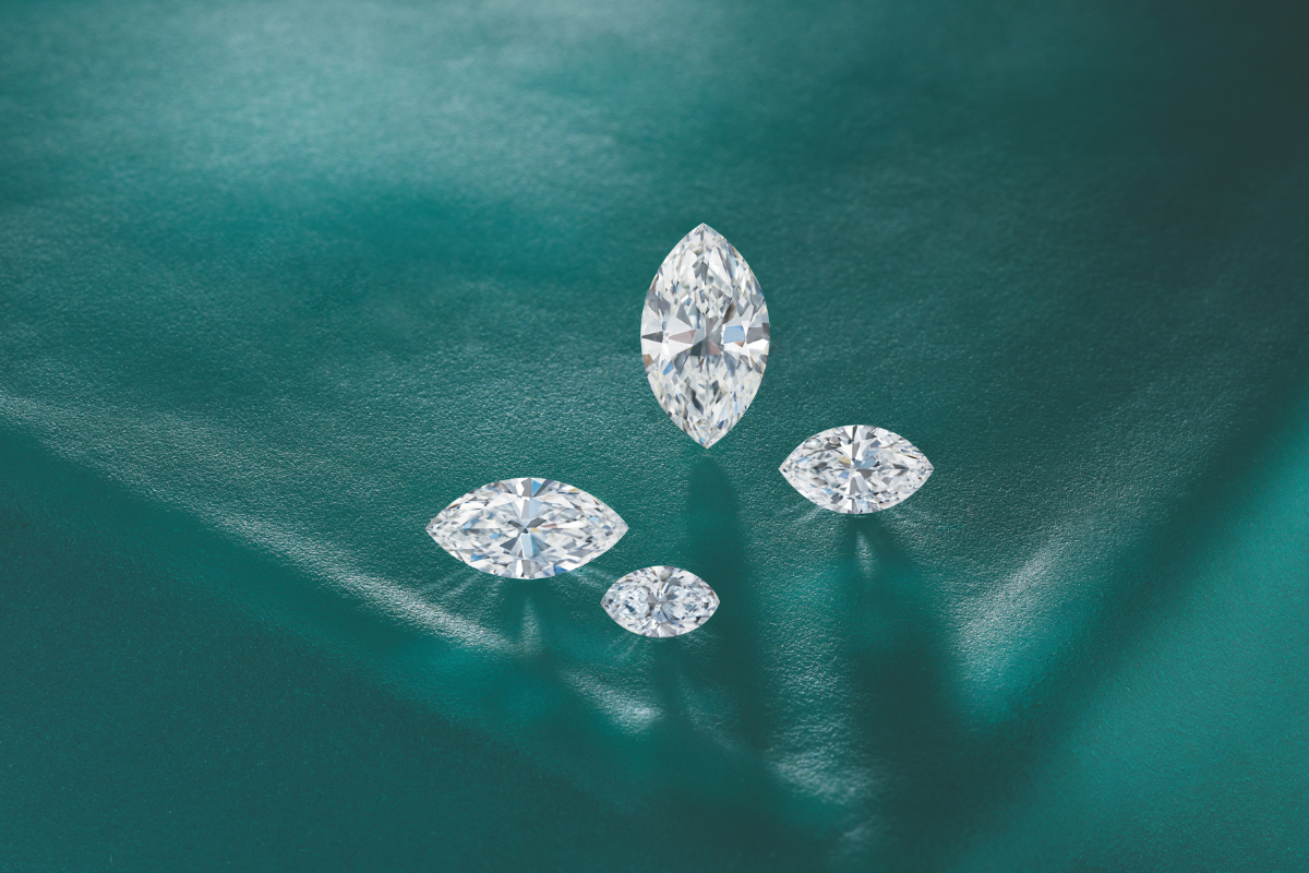 Loose Lab-Grown Diamonds and Gemstones on Green Background blog post by Soha Diamond Co. Jewelry Store in Madison, WI