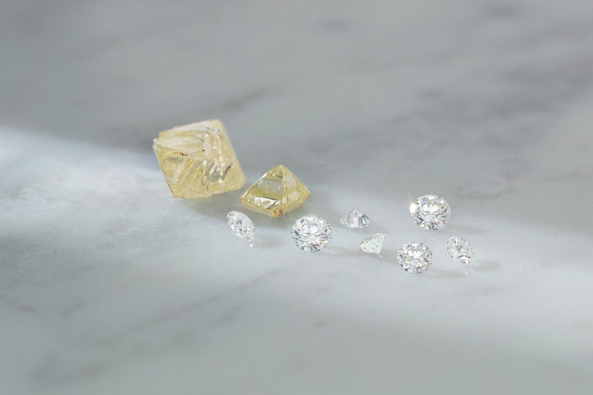 Loose Rough and Natural Canadian Diamonds on Gray Background What Are Canadian Diamonds blog post by Soha Diamond Co. Engagement Rings in Madison, Wisconsin