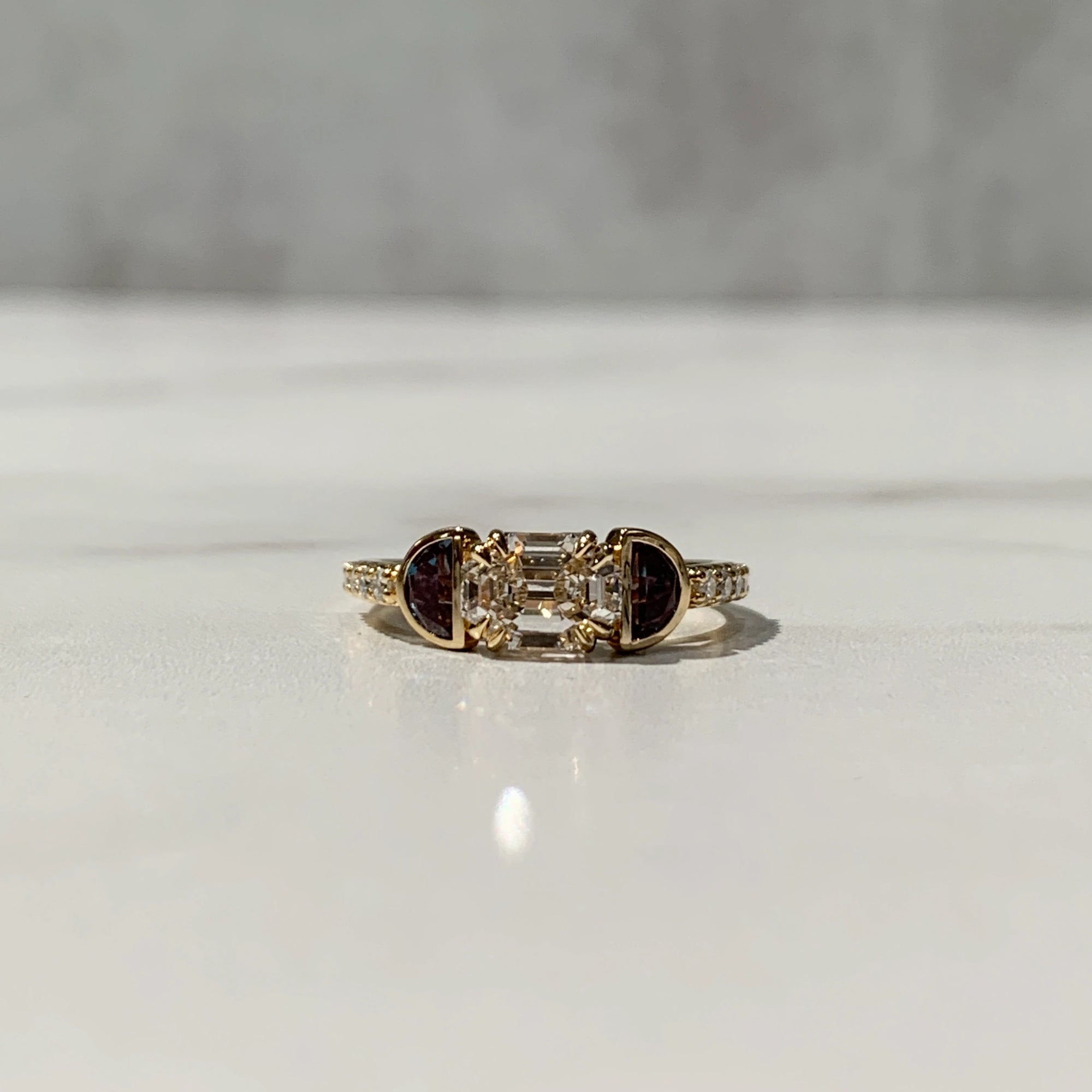 three-stone engagement ring with half moon alexandrite gemstones