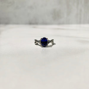 Blue sapphire engagement ring with aqua spinel side stones