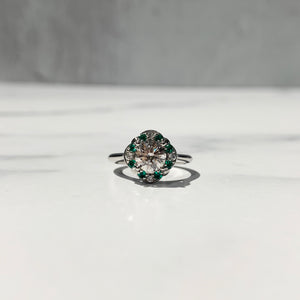 Halo engagement ring with emerald and diamond