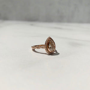Infinity inspired engagement ring with bezel set pear diamond