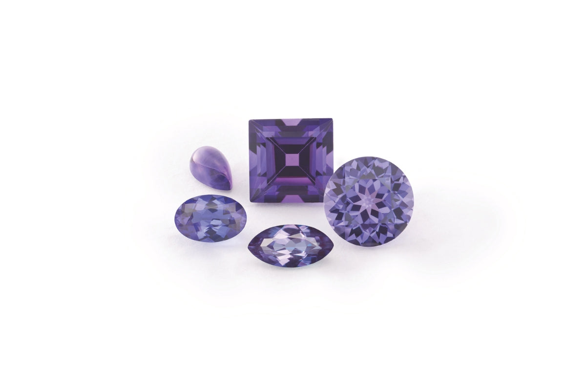 Amethyst Loose Faceted Gemstones on white background Blog Post Colored Gemstone Engagement Rings by Soha Diamond Co. in Madison, Wisconsin