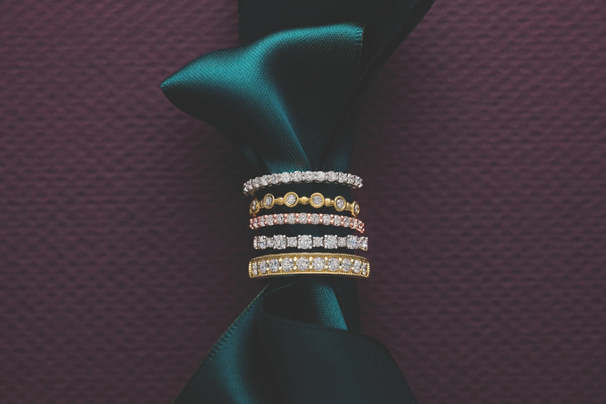 Soha Diamond Co. History of Wedding Bands Jeweler in Madison, Wisconsin Stackable Wedding Rings on Green Velvet Purple Background