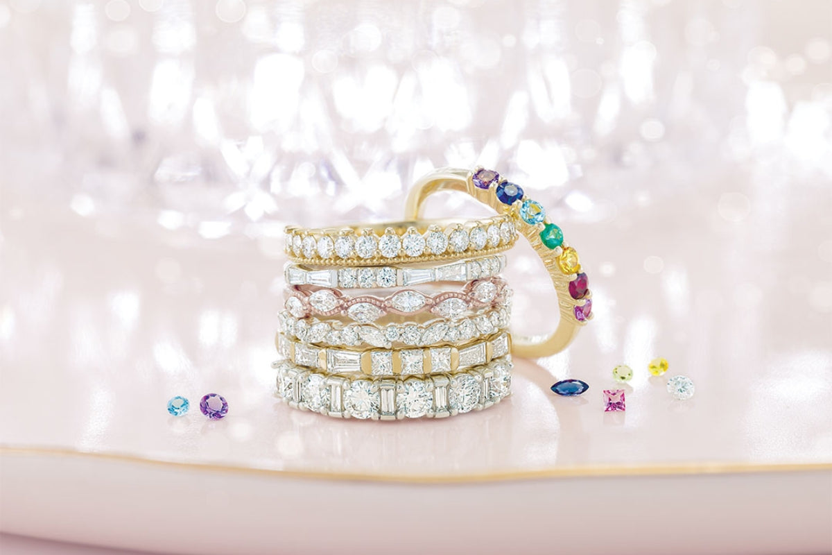 Soha Diamond Co. Wedding Band Stack on Pink Background The Ultimate Guide to Gemstones and Lab-Grown Diamonds in Wedding Bands for Madison, Wisconsin Couples Blog Post Jeweler in Madison, Wisconsin