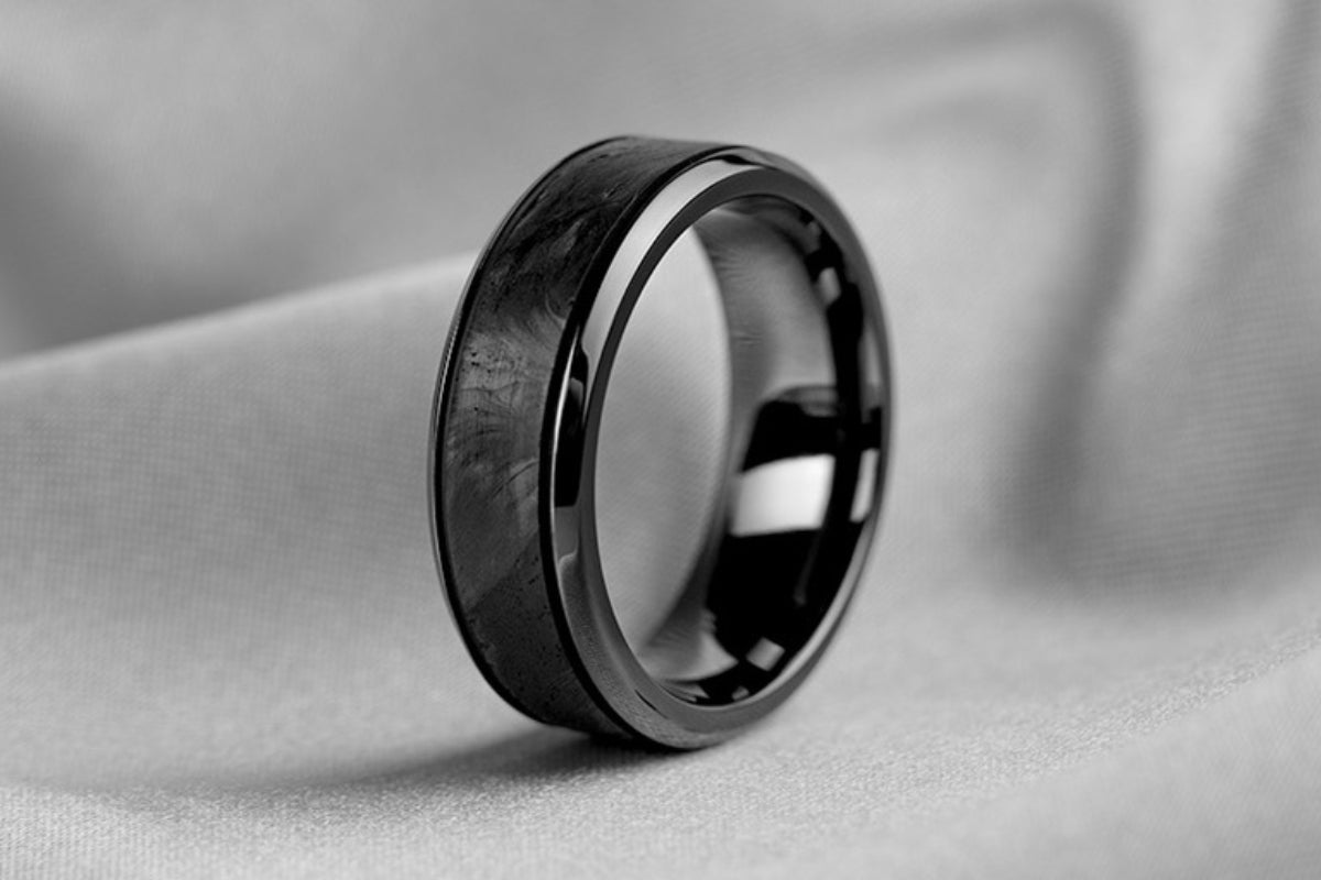 Soha Diamond Co. Black Ring on Gray Background What You Need to Know About Men’s Carbon Fiber Wedding Bands Blog Post Jeweler in Madison, Wisconsin