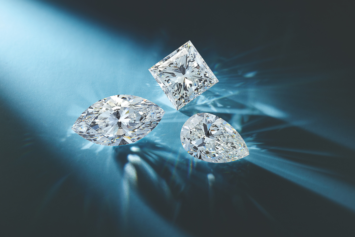 Loose Lab-Grown Diamonds on Blue Background - blog post by Soha Diamond Co. Jewelry Store in Madison, WI