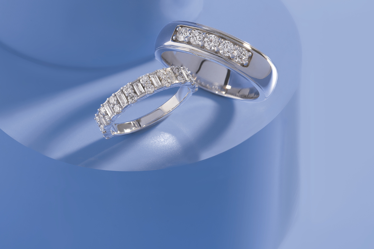 five stone engagement rings on blue background - blog post by Soha Diamond Co. Jewelry Store in Madison, WI