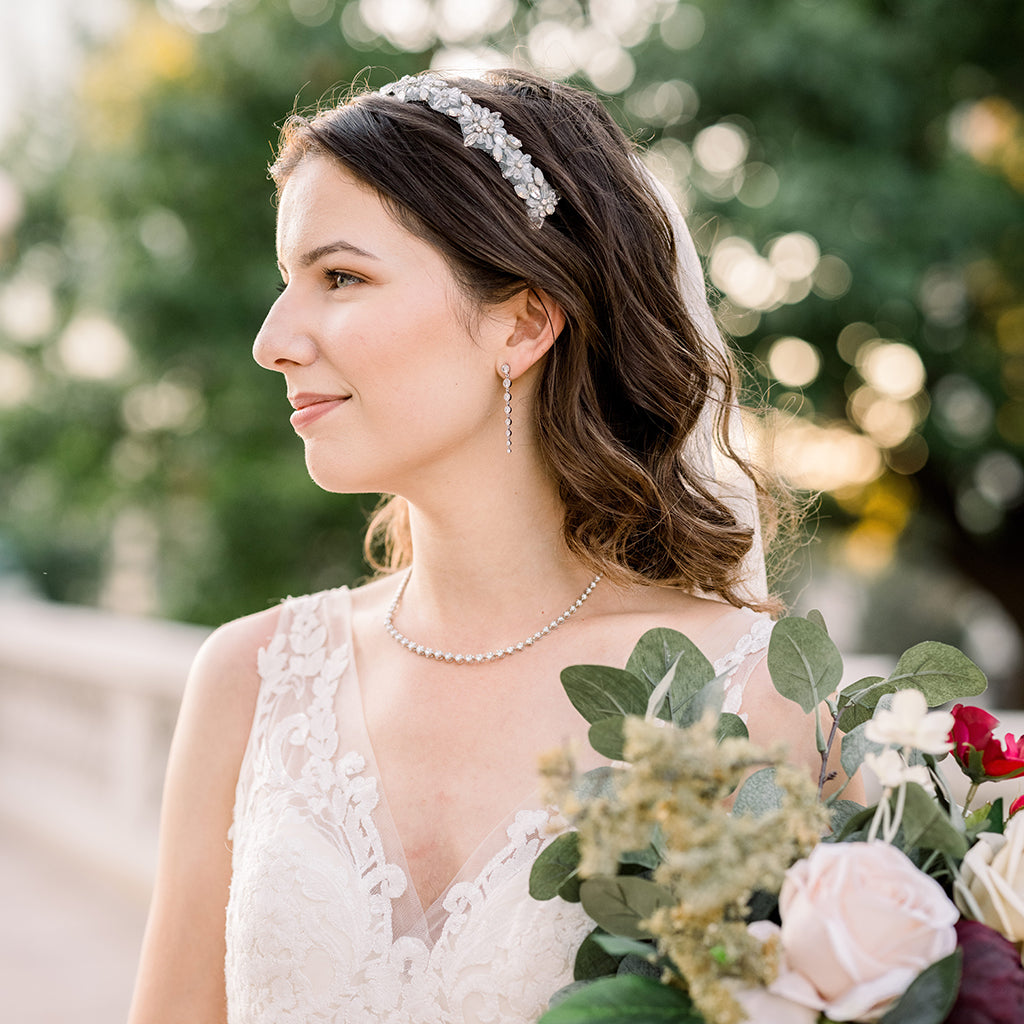 Bride wears diamond earrings and necklace