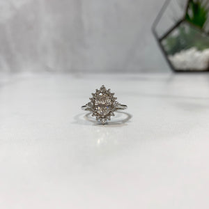 Halo engagement ring with oval diamond center