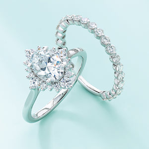 Halo engagement ring with oval diamond and single pronged wedding band
