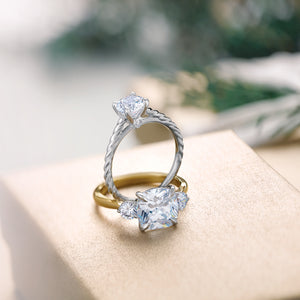 Twisted rope inspired solitaire with cushion cut three stone ring