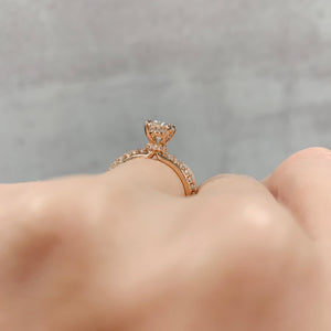 Rose gold oval engagement ring with hidden halo