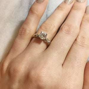 Vintage floral inspired solitaire engagement ring on hand