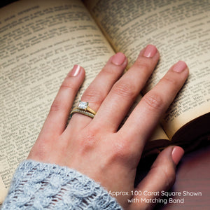 Yellow gold engagement ring on hand with wedding band opening a book