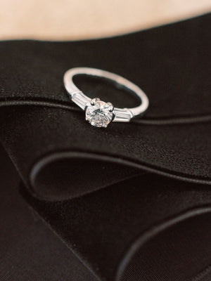 Tapered baguette three stone ring with round diamond