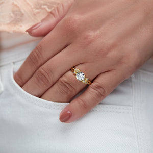Floral inspired engagement ring in yellow gold on woman's hand