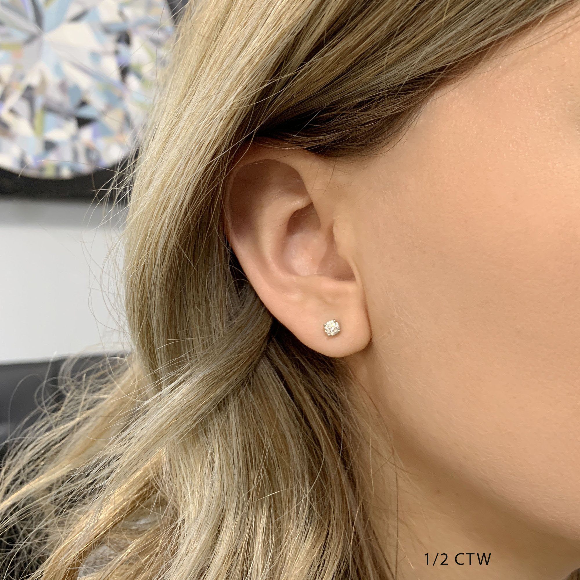 Half carat diamond store earrings on ear