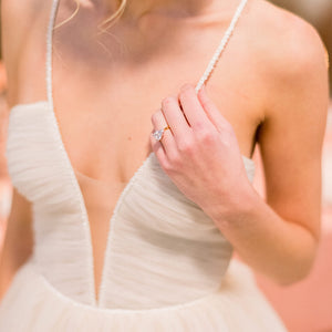 Bride wears three-stone cushion two tone engagement ring